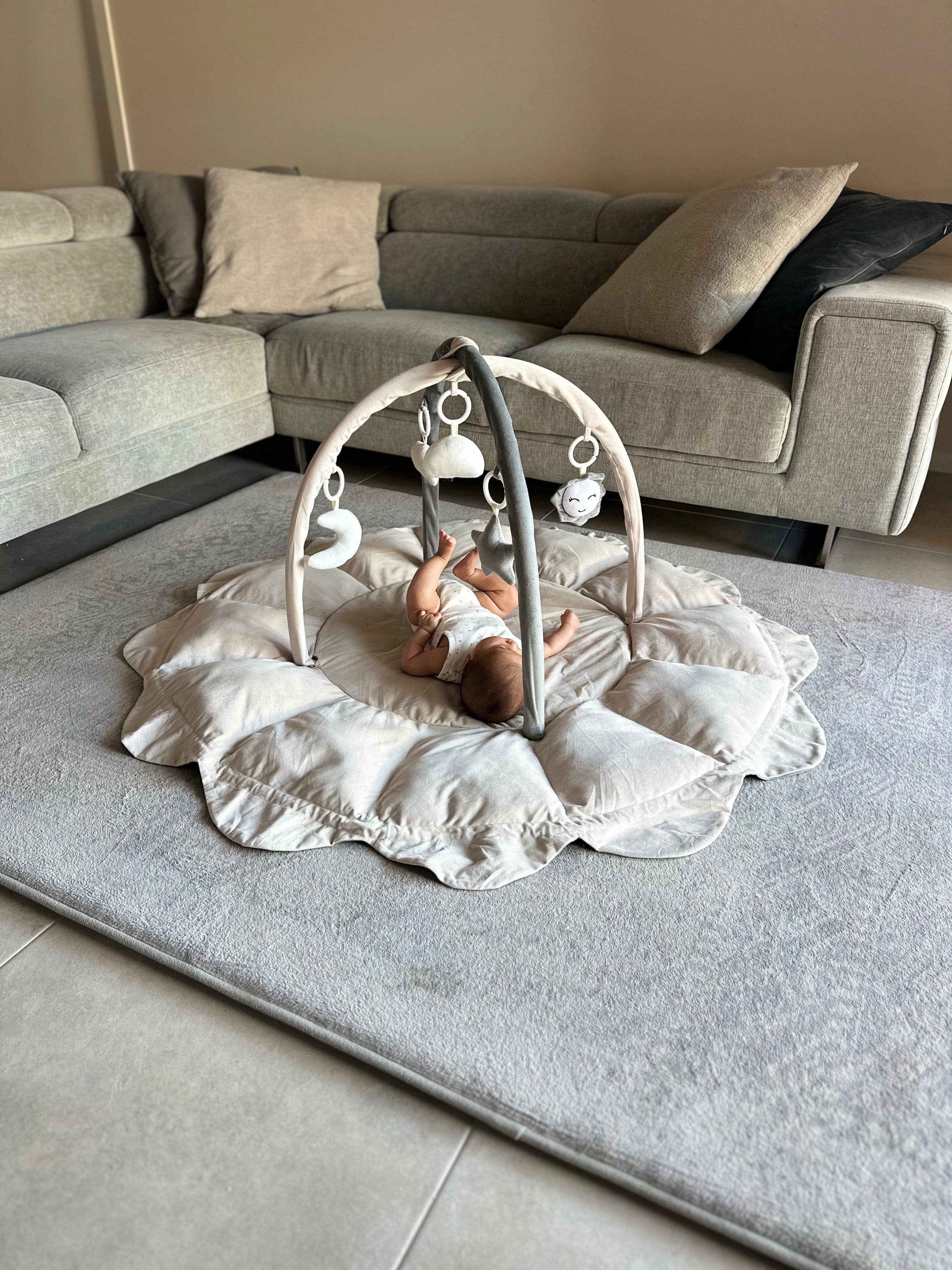 Baby lying on a Lumee Novi play gym in aesthetic living room