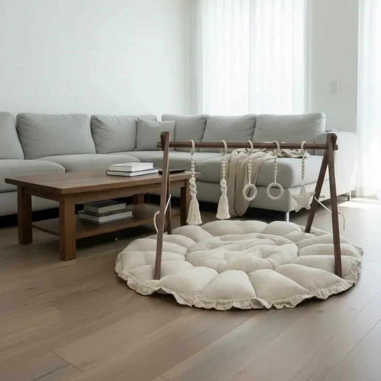 Lumee Sylvie baby play mat with a wooden toy mobile in a modern living room