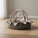 Lumee Novi baby play gym with hanging toys on a wooden floor