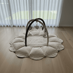 Luxury baby play mat with hanging toys mobile on a wooden floor